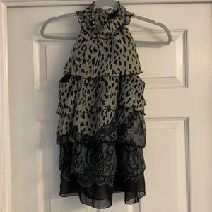 A high collar ruffle sleeveless top.